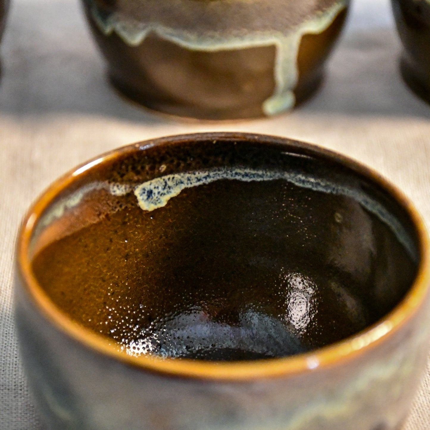 Handmade ceramic salsa bowl by Leigh Art featuring Espuela glaze with one-of-a-kind earth-tone movement and wheel-thrown craftsmanship.