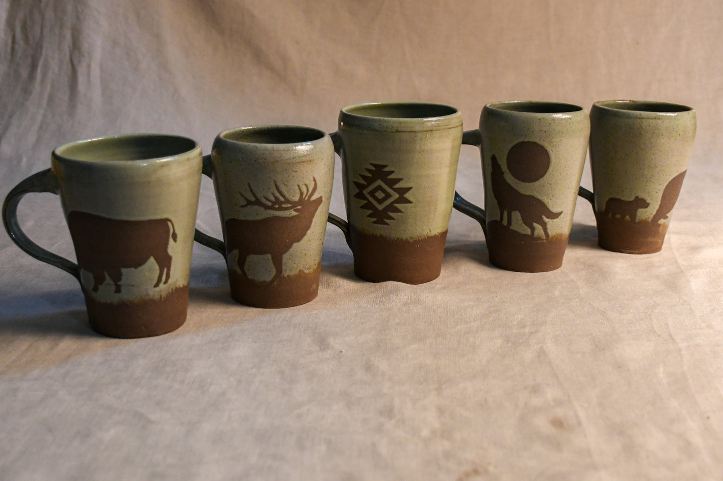 Wild Rojo 5-mug set in sage green with 5 original designs of a bison, elk, aztec, wolf, and bears.