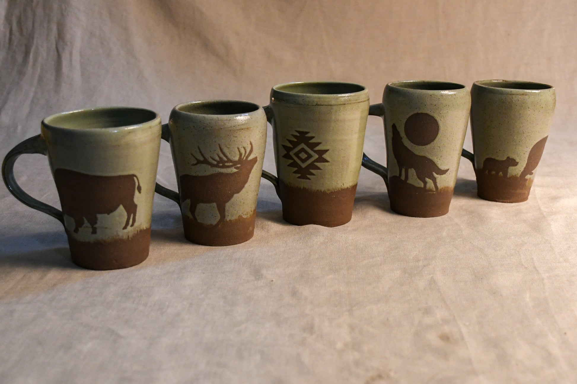 Wild Rojo 5-mug set in sage green with 5 original designs of a bison, elk, aztec, wolf, and bears.