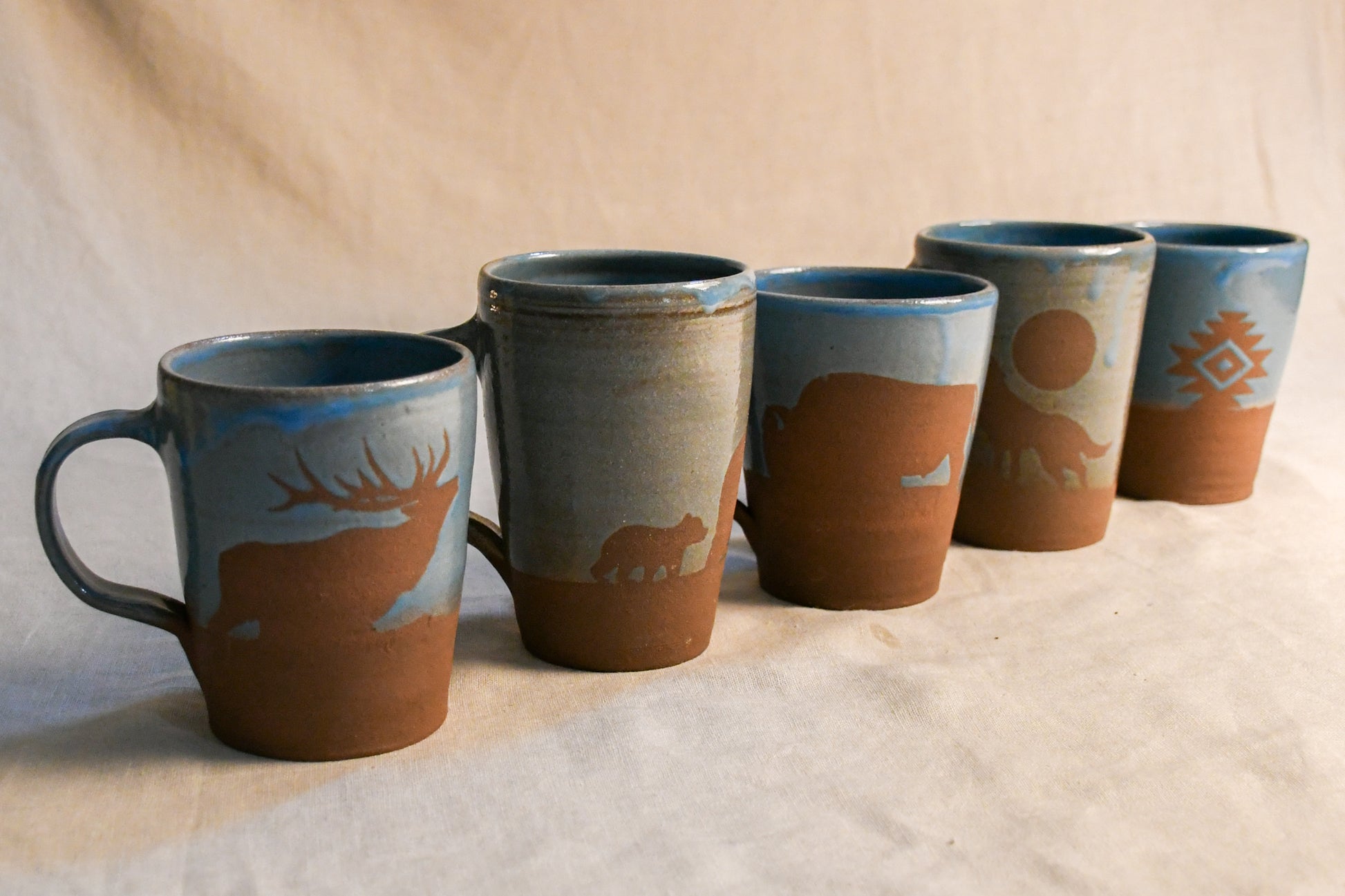 Wild Rojo 5-mug set in turquoise with 5 original designs of a bison, elk, aztec, wolf, and bears.