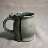 Grey handmade pottery mug with black drips from the 5th Buffalo collection by Leigh Art