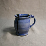 Purple handmade pottery mug with black drips from the 5th Buffalo collection by Leigh Art