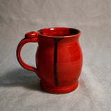 Red handmade pottery mug with black drips from the 5th Buffalo collection by Leigh Art