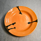Orange handmade wheelthrown pottery dinner plate from the 5th Buffalo collection by Leigh Art