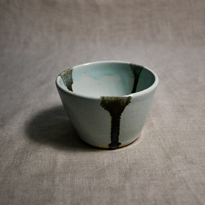 Pale blue handmade wheelthrown salsa bowl with black drips from the 5th Buffalo collection by Leigh Art.