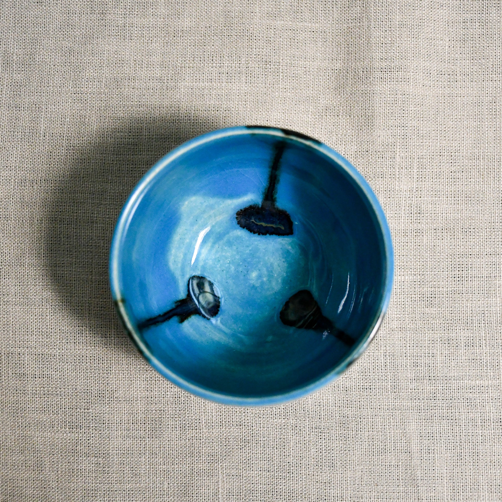 Interior image of a turquoise handmade wheelthrown salsa bowl from the 5th Buffalo collection by Leigh Art.