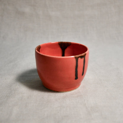 Coral handmade wheelthrown salsa bowl with black drips from the 5th Buffalo collection by Leigh Art.