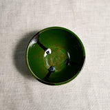 Interior image of a green handmade wheelthrown salsa bowl with black drips from the 5th Buffalo collection by Leigh Art.