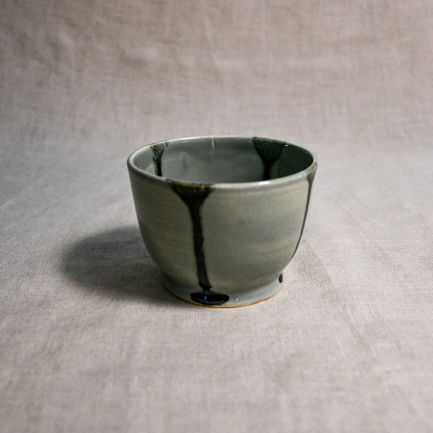 Grey handmade wheelthrown salsa bowl with black drips from the 5th Buffalo collection by Leigh Art.