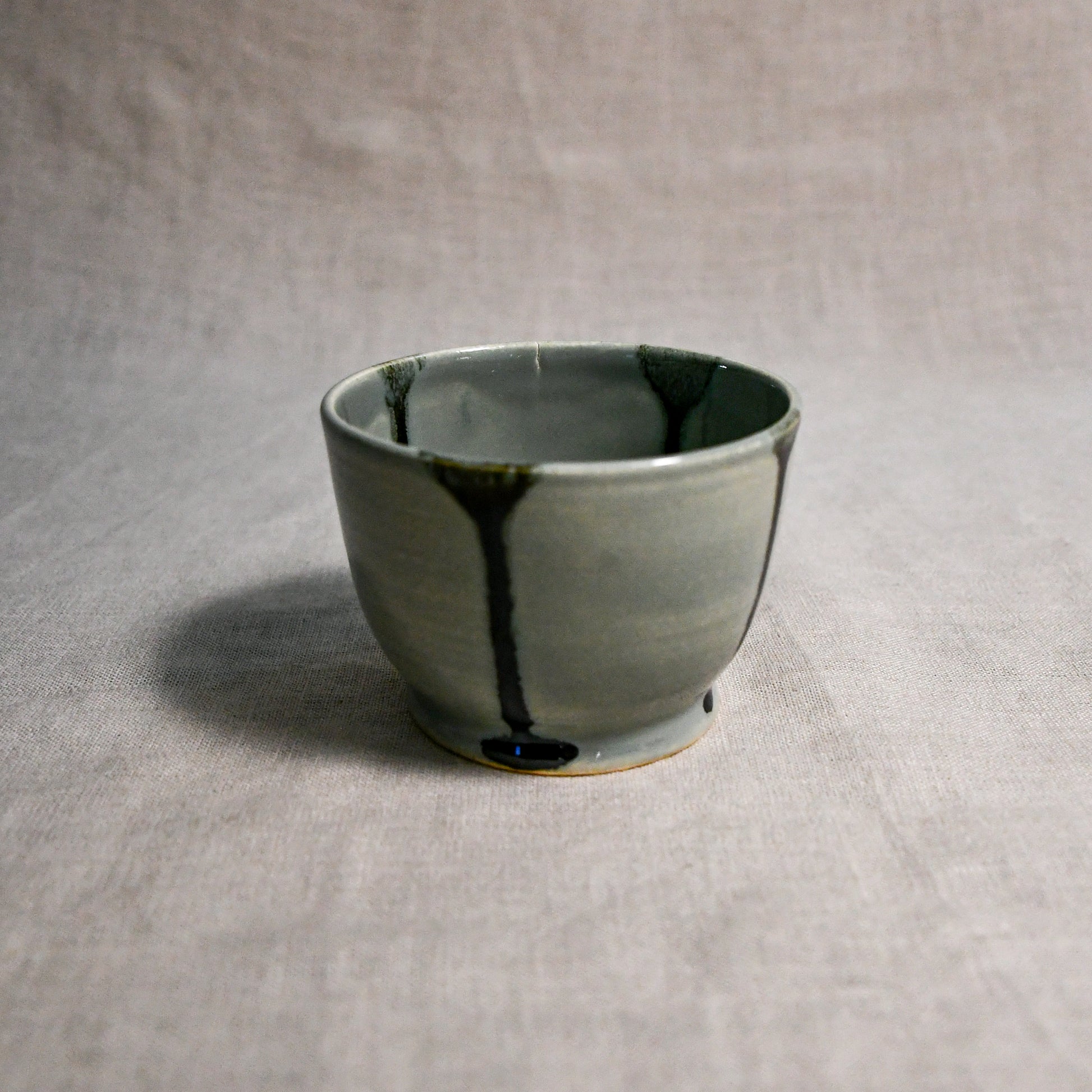 Grey handmade wheelthrown salsa bowl with black drips from the 5th Buffalo collection by Leigh Art.
