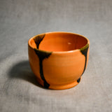 Orange handmade wheelthrown salsa bowl with black drips from the 5th Buffalo collection by Leigh Art.