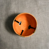 Interior image of a orange handmade wheelthrown salsa bowl from the 5th Buffalo collection by Leigh Art.