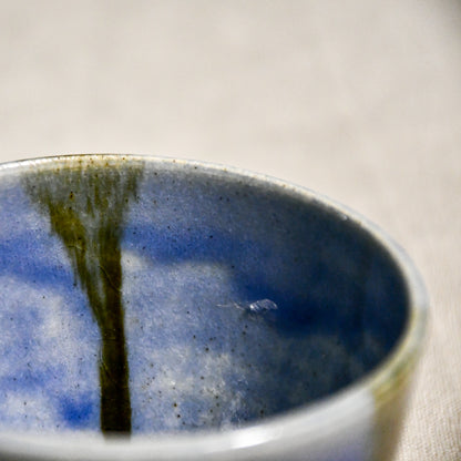 Close up of purple handmade wheelthrown pottery salsa bowl from the 5th Buffalo collection by Leigh Art showing black drips and texture. 