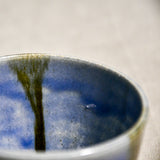 Close up of purple handmade wheelthrown pottery salsa bowl from the 5th Buffalo collection by Leigh Art showing black drips and texture. 