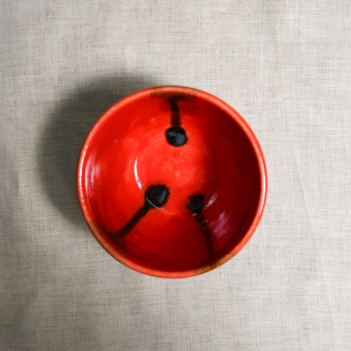 Interior image of a red handmade wheelthrown salsa bowl from the 5th Buffalo collection by Leigh Art.