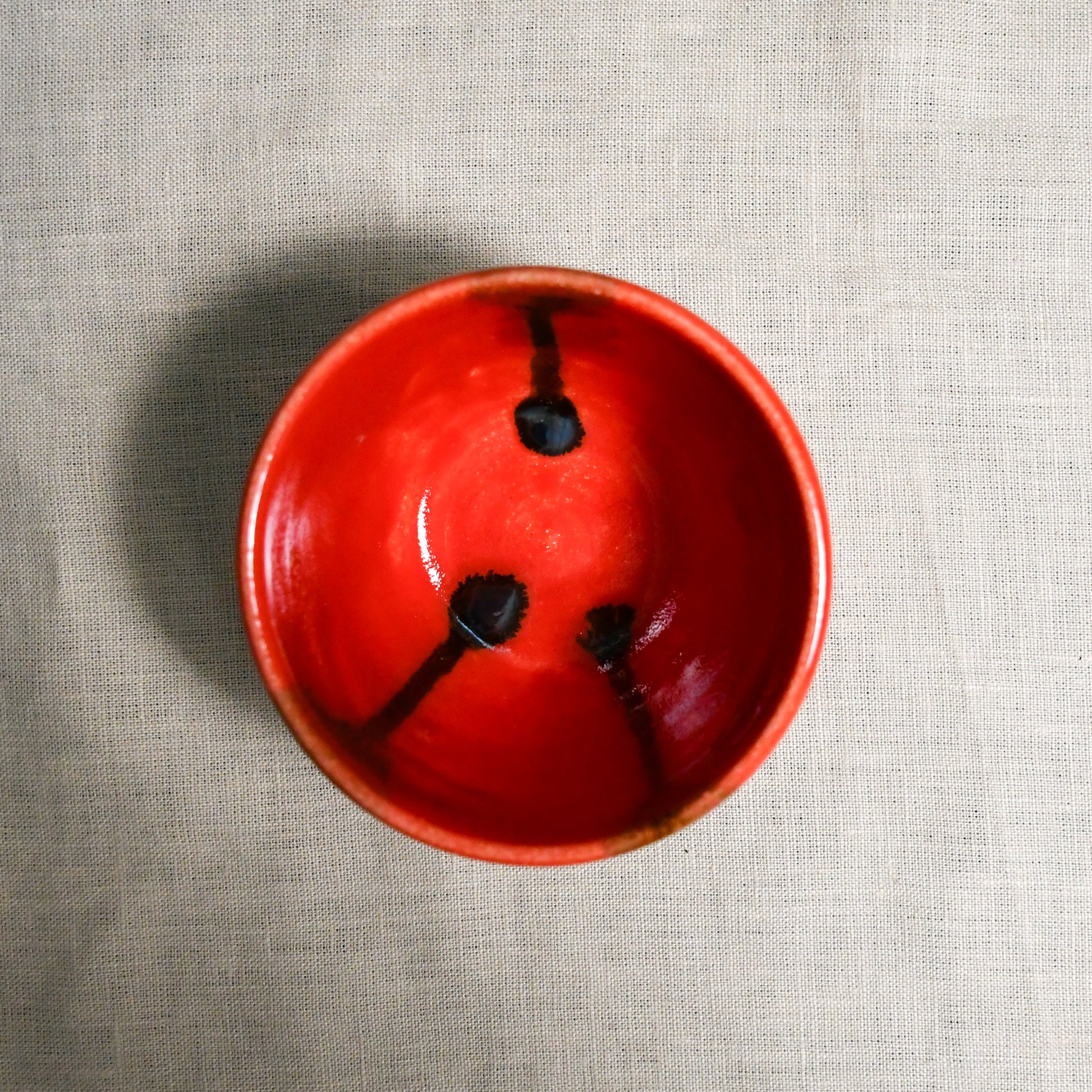 Interior image of a red handmade wheelthrown salsa bowl from the 5th Buffalo collection by Leigh Art.