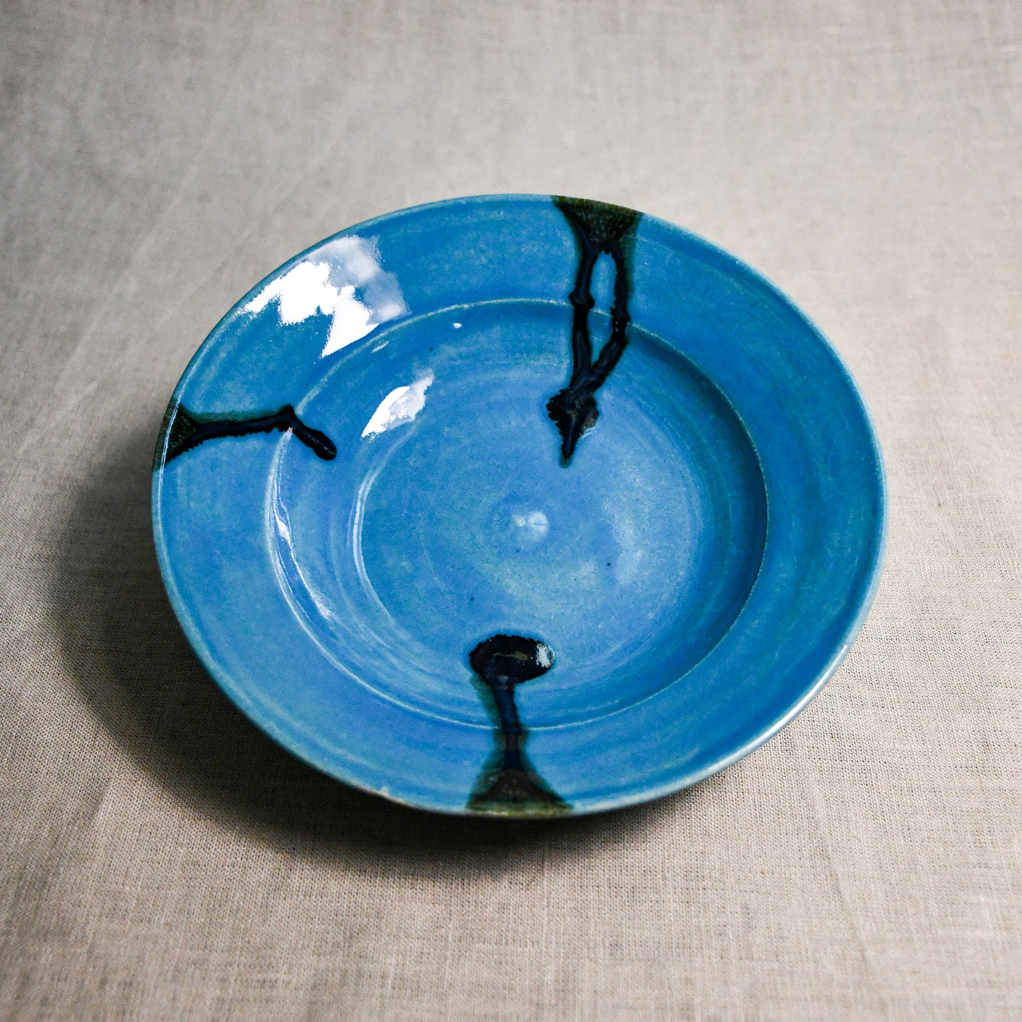 Turquoise handmade wheelthrown pottery saucer from the 5th Buffalo collection by Leigh Art