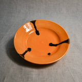Orange handmade wheelthrown pottery saucer from the 5th Buffalo collection by Leigh Art