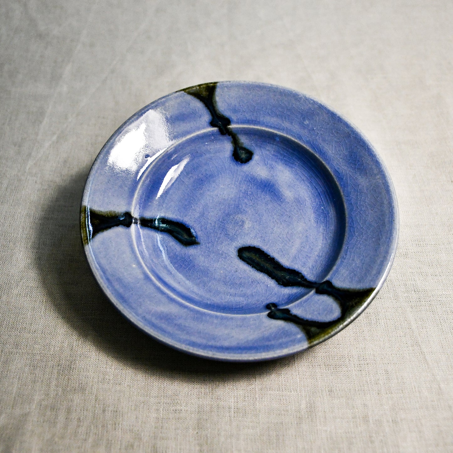 Purple handmade wheelthrown pottery saucer from the 5th Buffalo collection by Leigh Art