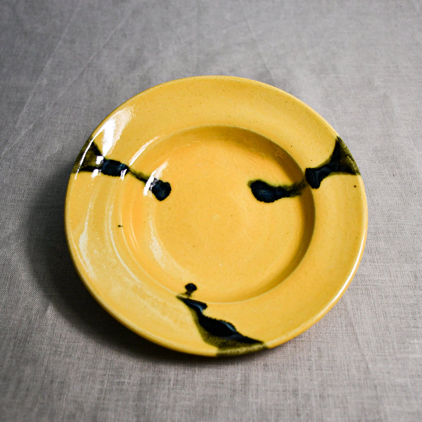 Yellow handmade wheelthrown pottery saucer from the 5th Buffalo collection by Leigh Art