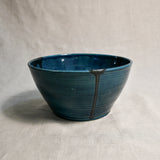 Side view of dark teal handmade wheelthrown serving bowl with black drips from the 5th Buffalo collection from Leigh Art. 