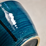 Close up of dark teal handmade wheelthrown serving bowl with black drips and texture from the 5th Buffalo collection from Leigh Art. 