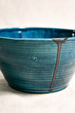Close up of dark teal handmade wheelthrown serving bowl with black drips from the 5th Buffalo collection from Leigh Art. 