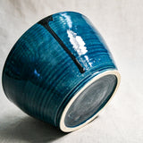 Bottom view of dark teal handmade wheelthrown serving bowl with black drips and texture from the 5th Buffalo collection from Leigh Art. 