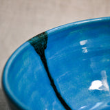Close up of turquoise handmade wheelthrown serving bowl with black drips and crazing from the 5th Buffalo collection from Leigh Art. 