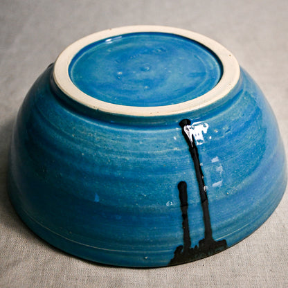 Bottom view of turquoise handmade wheelthrown serving bowl with black drips from the 5th Buffalo collection from Leigh Art. 