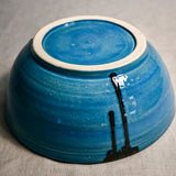 Bottom view of turquoise handmade wheelthrown serving bowl with black drips from the 5th Buffalo collection from Leigh Art. 