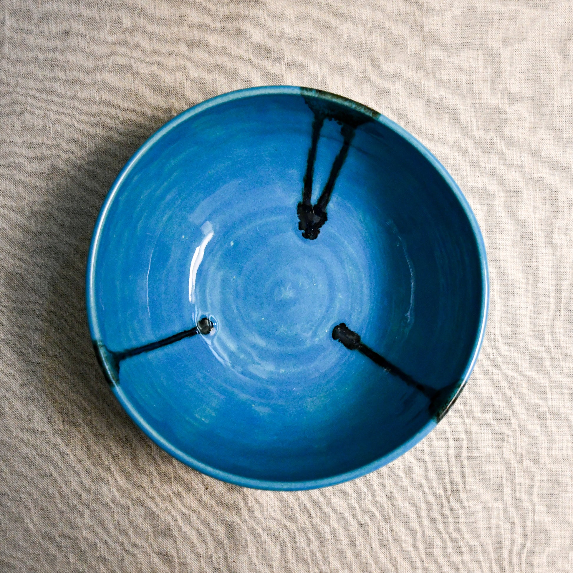 Interior image of a turquoise handmade wheelthrown serving bowl from the 5th Buffalo collection by Leigh Art.