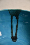Close up of turquoise handmade wheelthrown serving bowl with black drips from the 5th Buffalo collection from Leigh Art. 