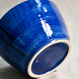Bottom view of blue handmade wheelthrown serving bowl with black drips and texture from the 5th Buffalo collection from Leigh Art. 