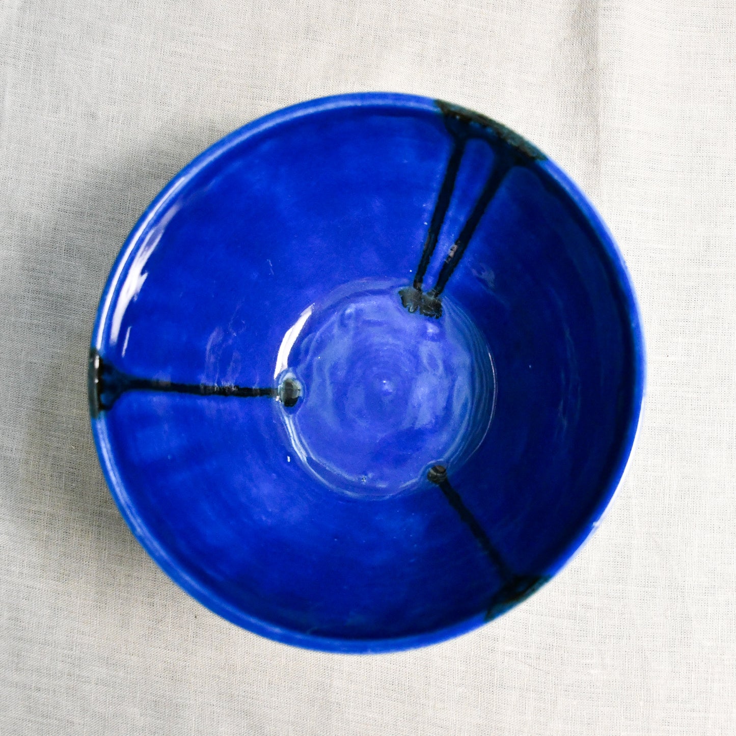 Interior image of a blue handmade wheelthrown serving bowl from the 5th Buffalo collection by Leigh Art.