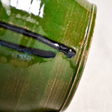 Close up of green handmade wheelthrown serving bowl with black drips and texture from the 5th Buffalo collection from Leigh Art. 