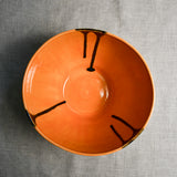 Interior image of a orange handmade wheelthrown serving bowl from the 5th Buffalo collection by Leigh Art.