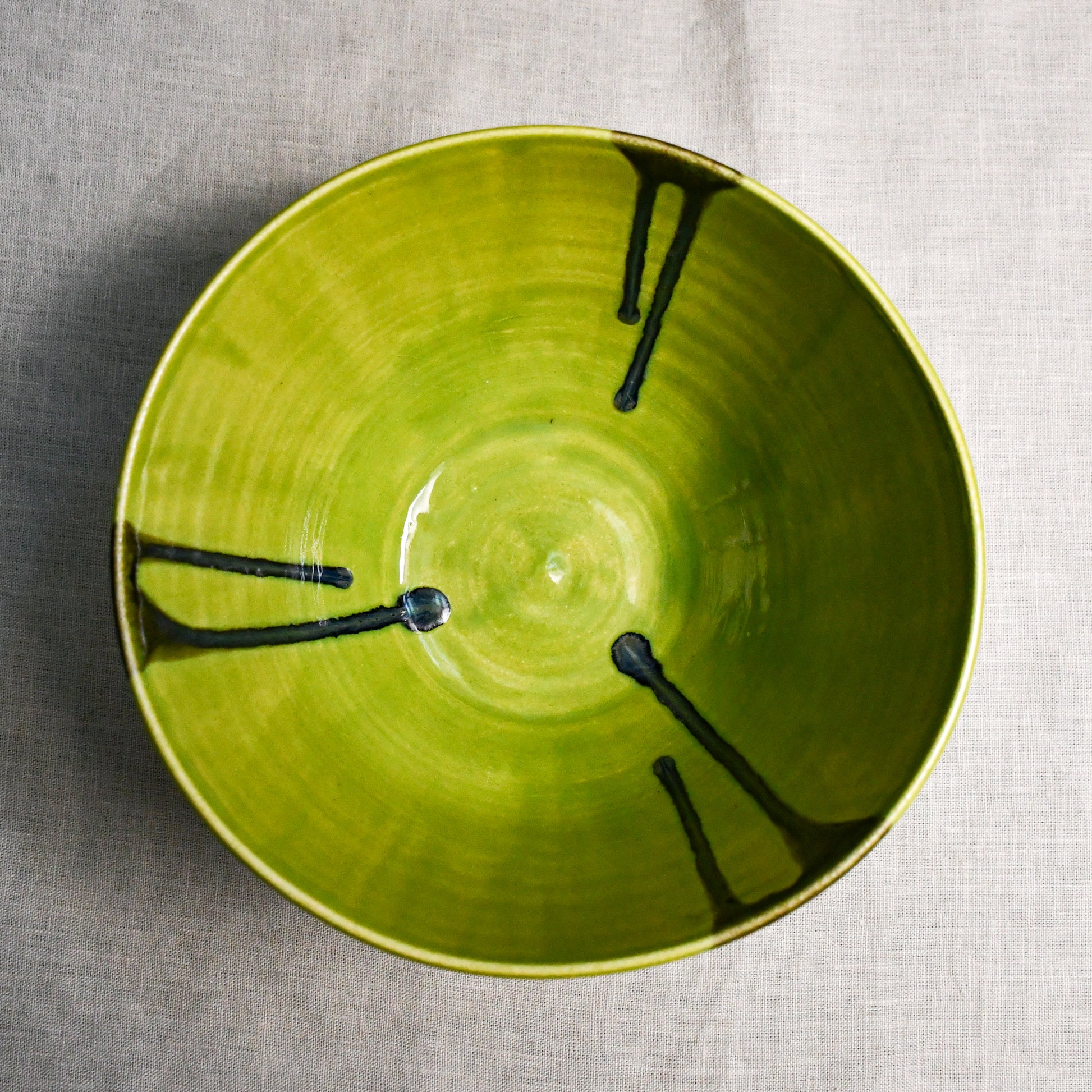 Interior image of a lime green handmade wheelthrown serving bowl from the 5th Buffalo collection by Leigh Art.