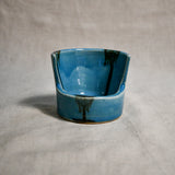 Close up of turquoise vertical handmade pottery spoon rest from the 5th Buffalo collection by Leigh Art with black drips