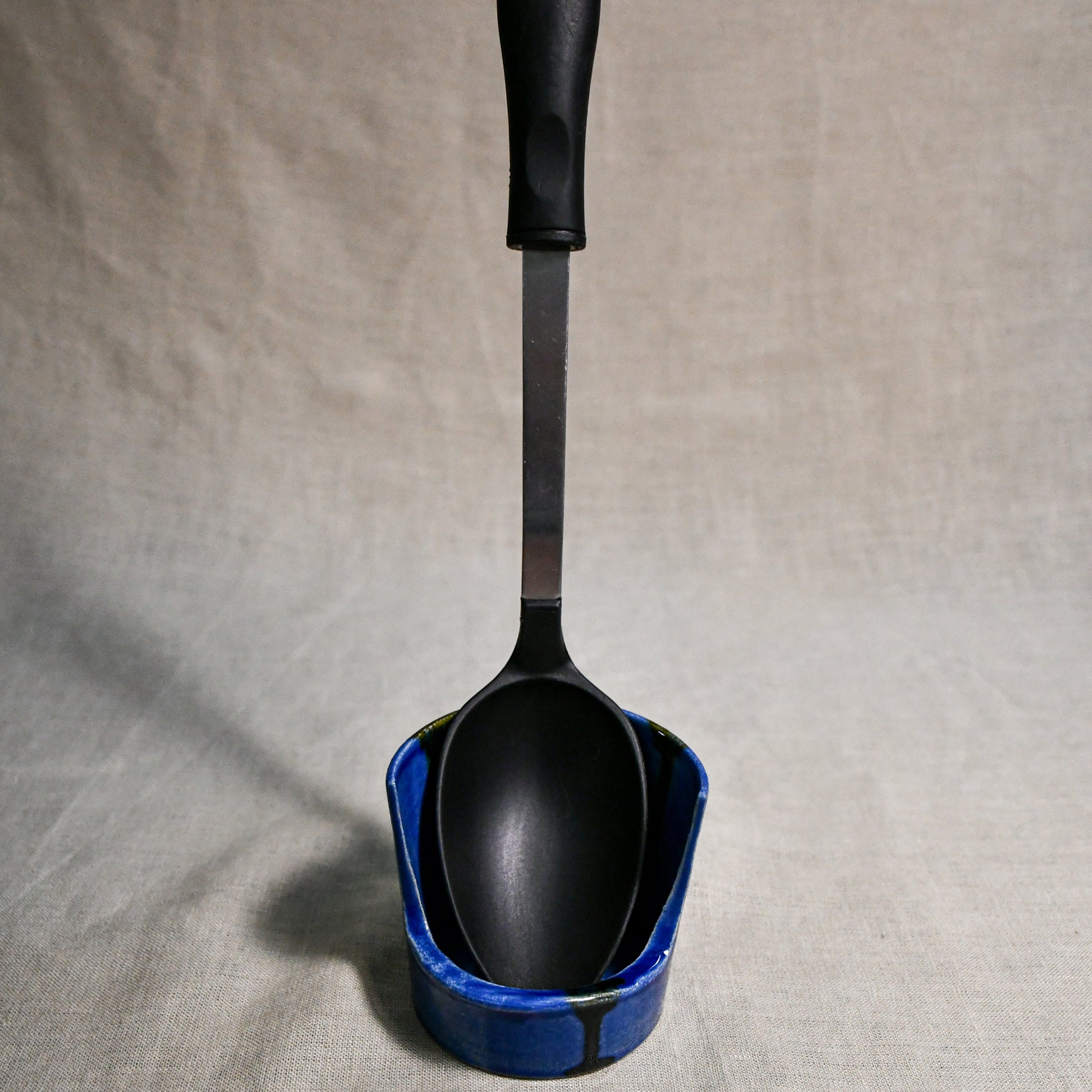 Vertical blue handmade spoon rest with serving spoon from the 5th Buffalo collection by Leigh Art