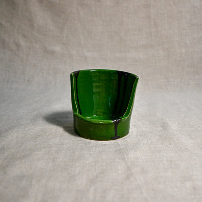 Close up of green vertical handmade pottery spoon rest from the 5th Buffalo collection by Leigh Art with black drips