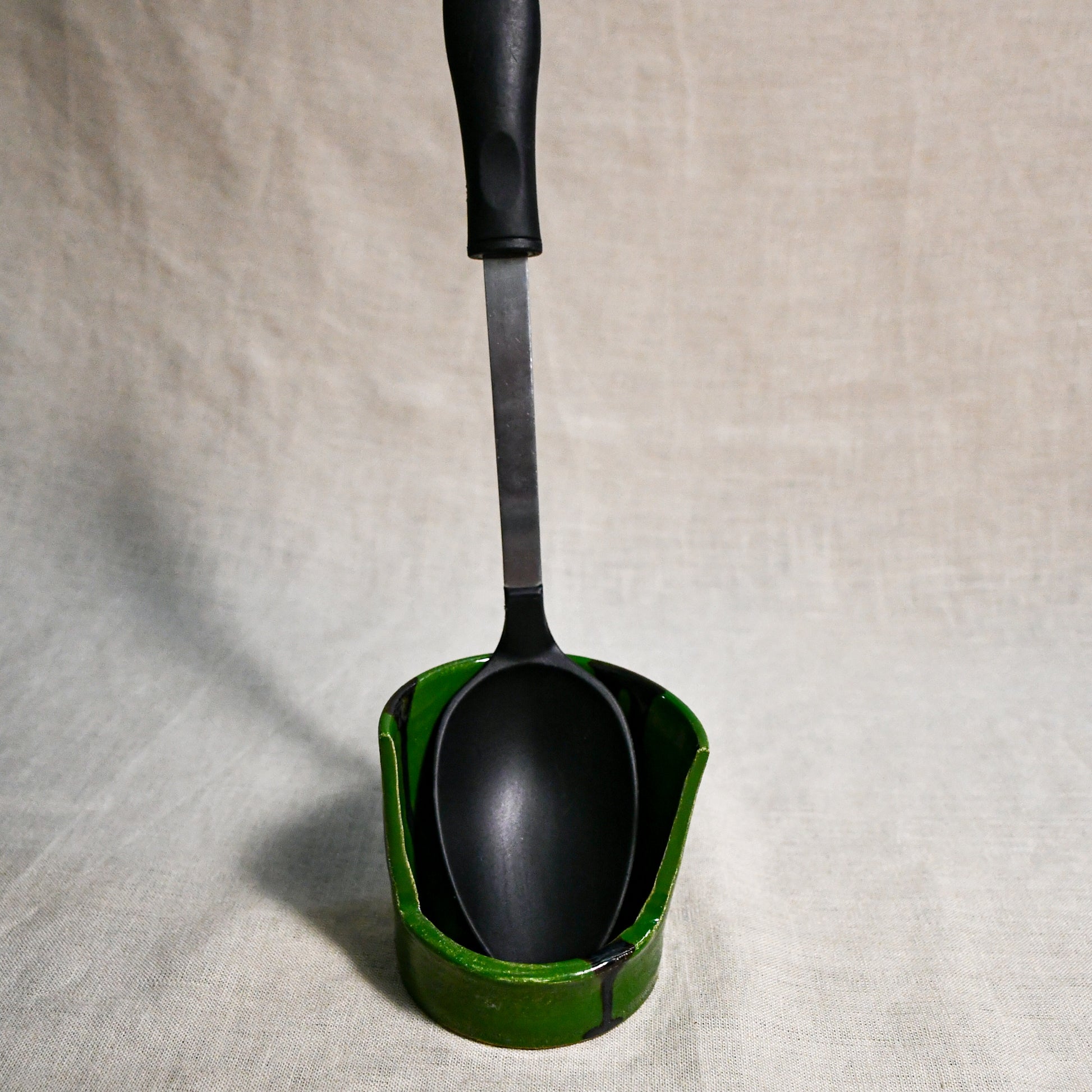 Vertical green handmade spoon rest with serving spoon from the 5th Buffalo collection by Leigh Art