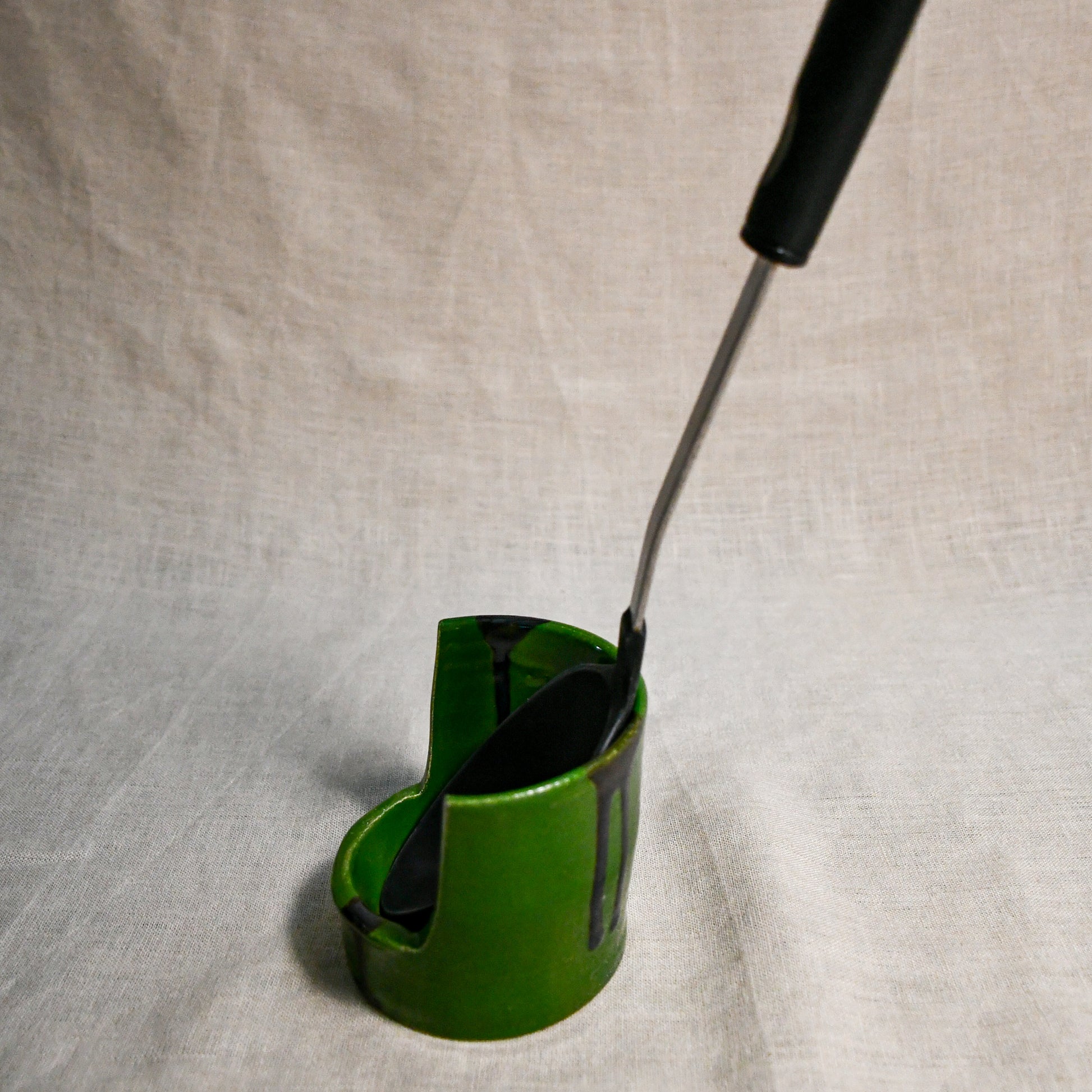 Side profile of vertical green handmade spoon rest with serving spoon from the 5th Buffalo collection by Leigh Art