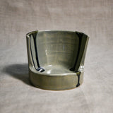 Close up of grey vertical handmade pottery spoon rest from the 5th Buffalo collection by Leigh Art with black drips 