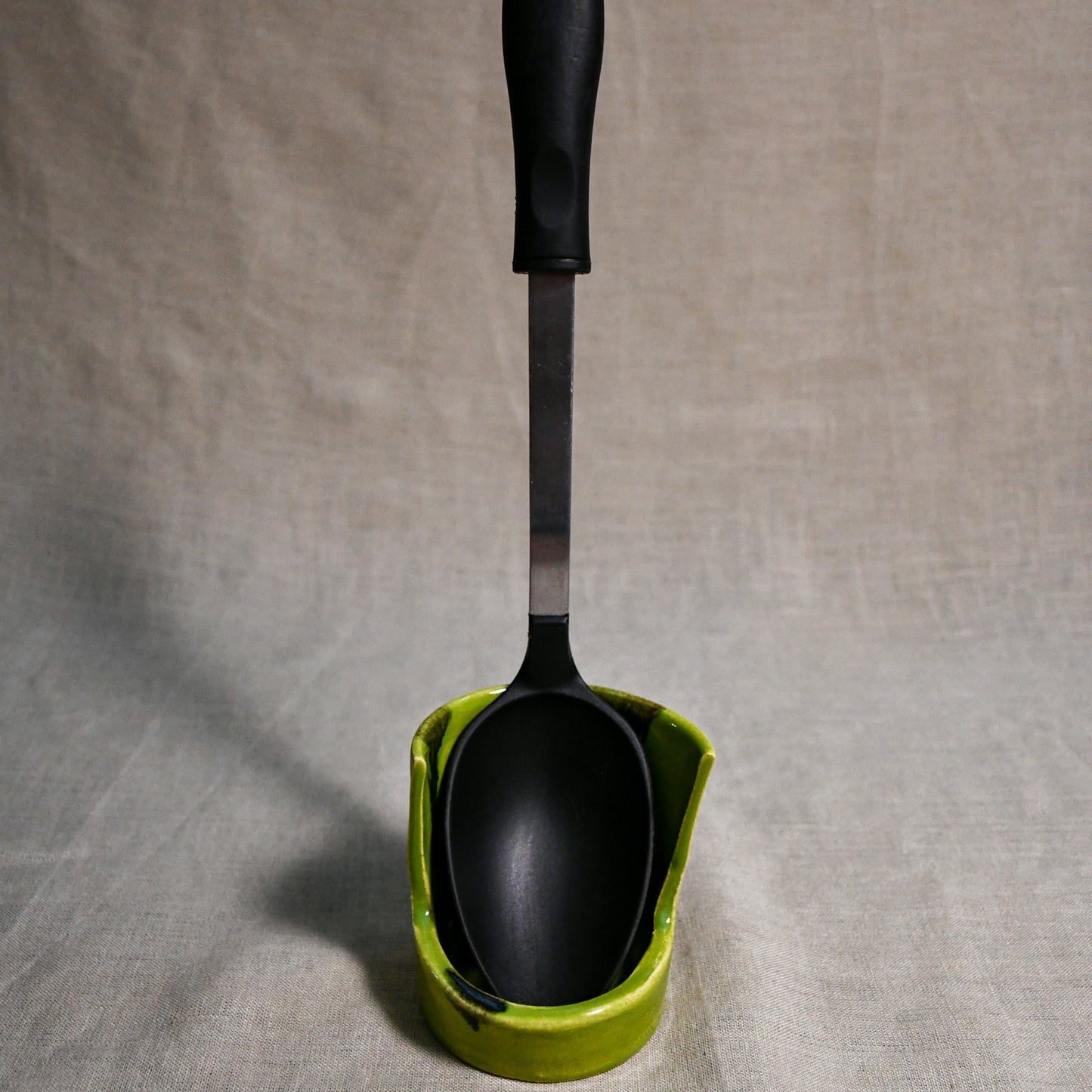 Vertical lime green handmade spoon rest with serving spoon from the 5th Buffalo collection by Leigh Art
