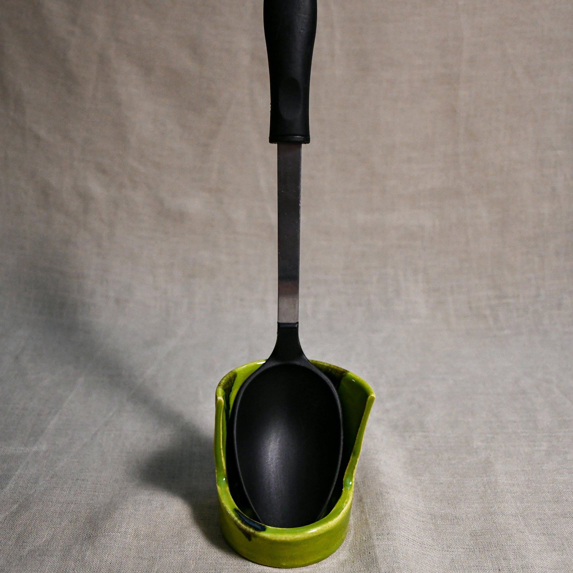 Vertical lime green handmade spoon rest with serving spoon from the 5th Buffalo collection by Leigh Art