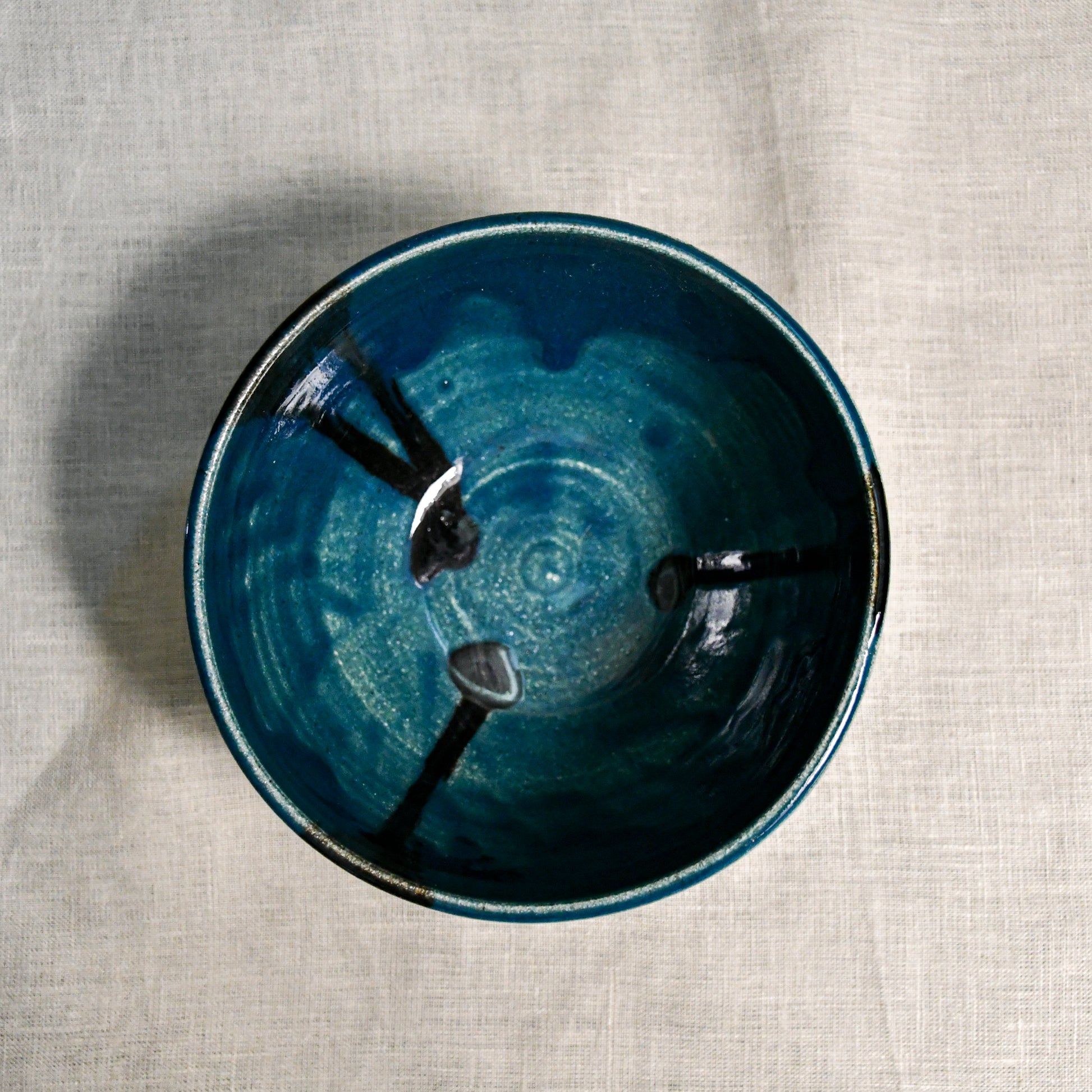 Interior image of a dark teal handmade wheelthrown chili bowl from the 5th Buffalo collection by Leigh Art.