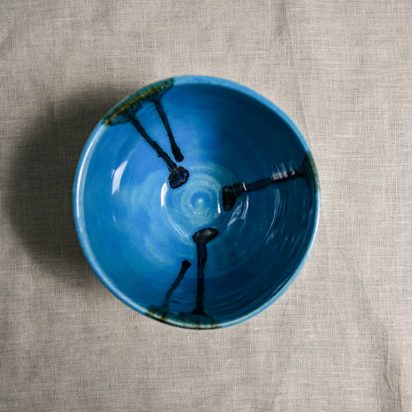 Interior image of a turquoise blue handmade wheelthrown chili bowl from the 5th Buffalo collection by Leigh Art.