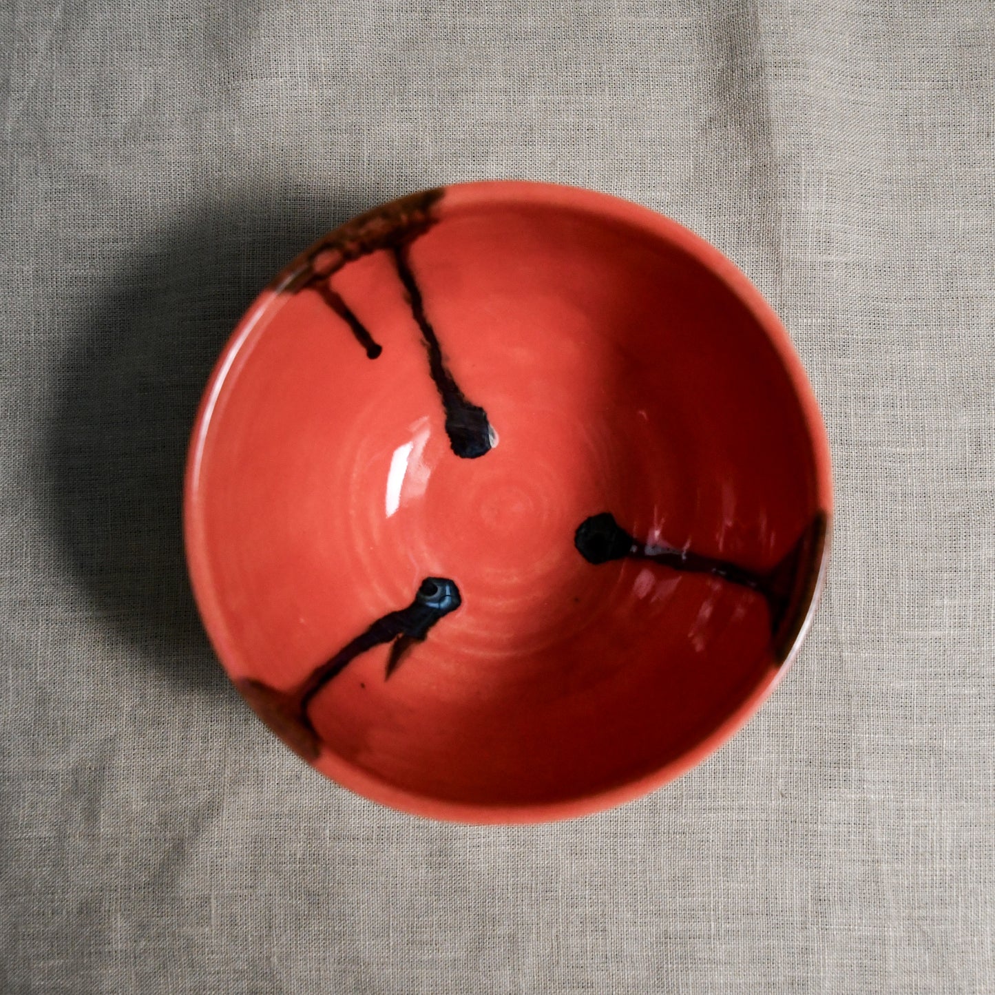 Interior image of a coral handmade wheelthrown chili bowl from the 5th Buffalo collection by Leigh Art.