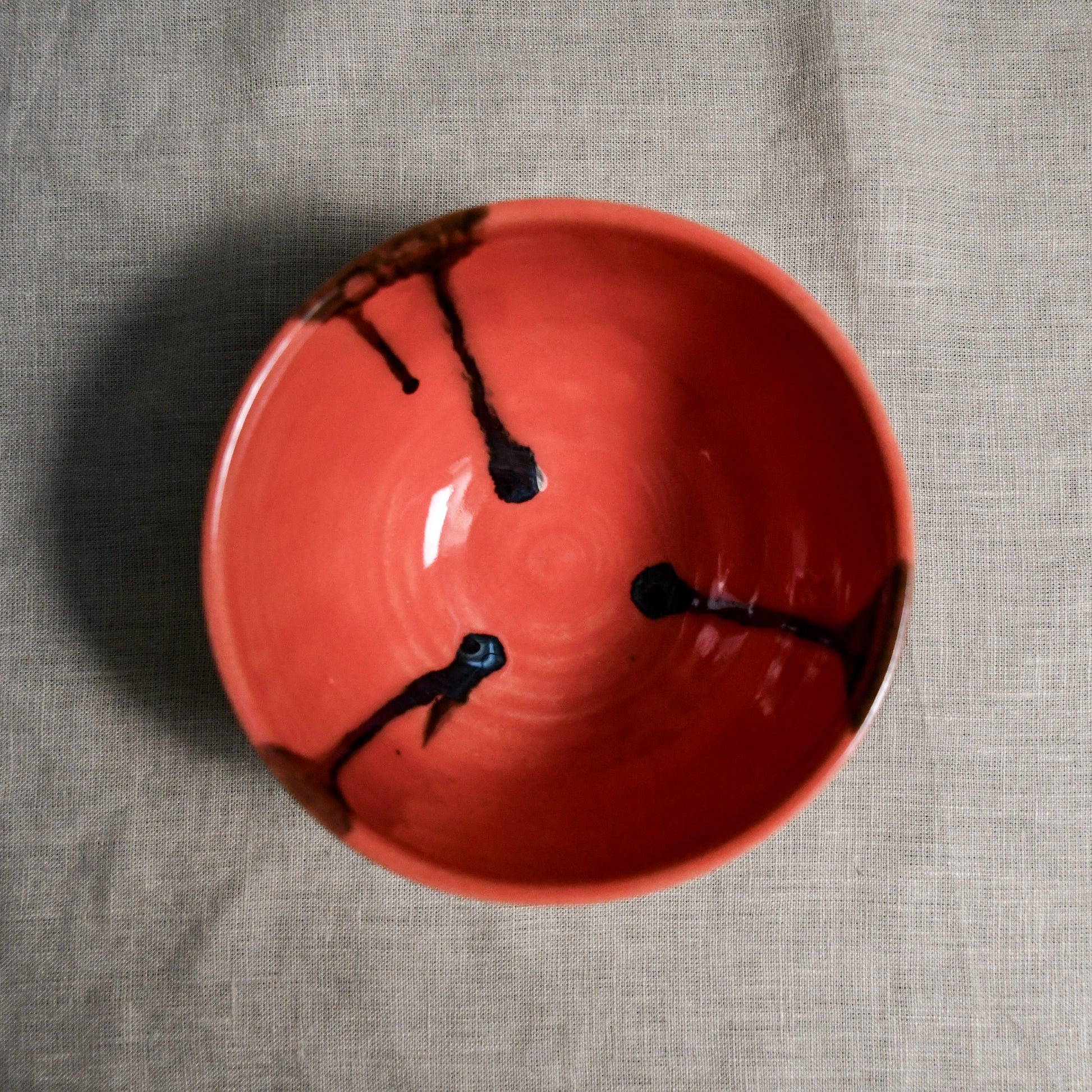 Interior image of a coral handmade wheelthrown chili bowl from the 5th Buffalo collection by Leigh Art.